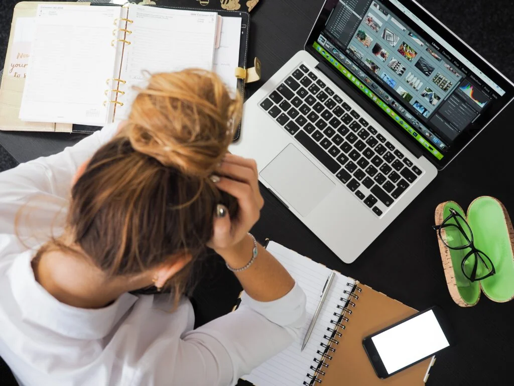 A frustrated Owner or Sales Manager reviewing reports on a laptop